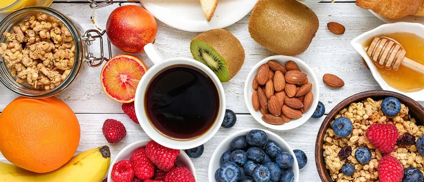 Top View einer Tasse schwarzem Kaffee der Kaffeerösterei Martermühle umringt von Obst